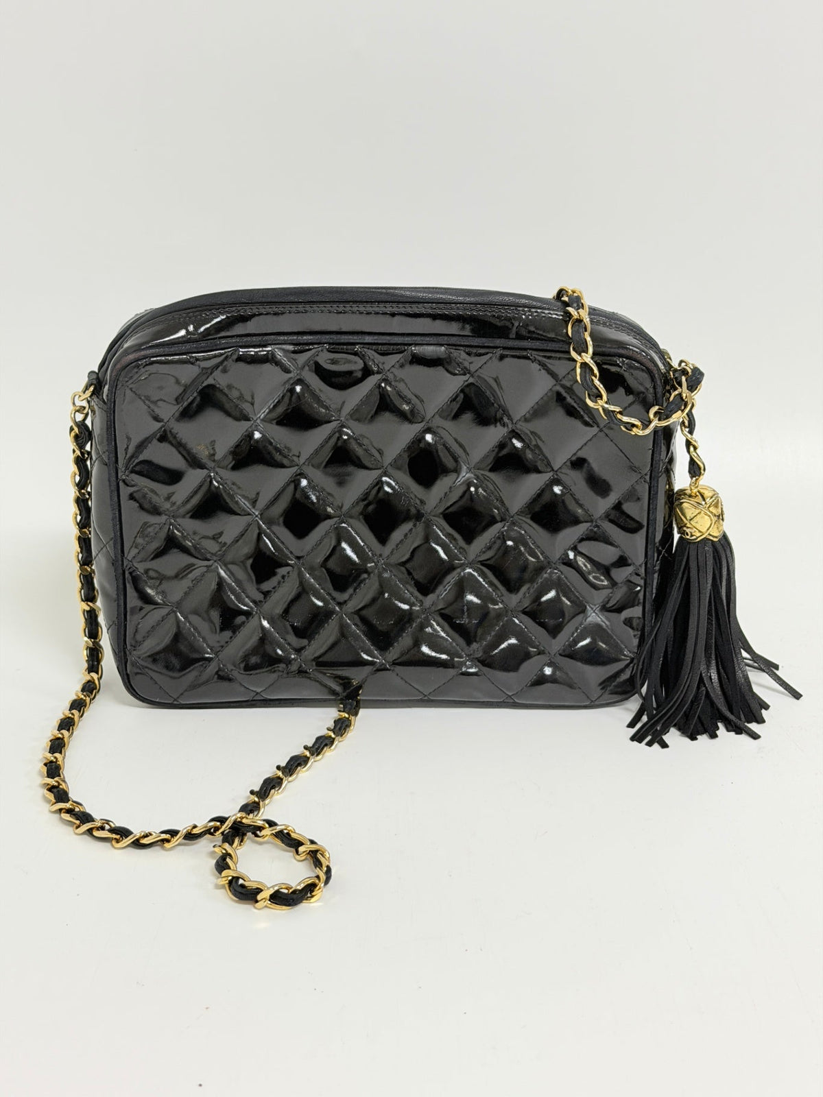 Lynn's Closet Boutique vintage black quilted patent leather Chanel camera bag with gold chain strap and tassel