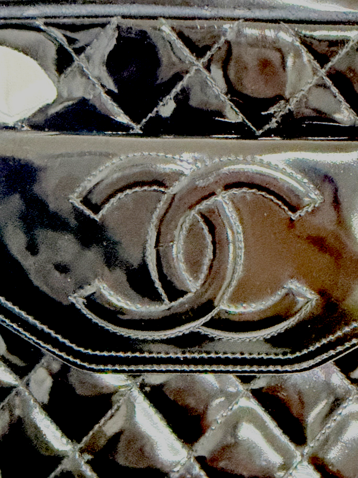 Lynn's Closet Boutique black quilted patent leather Chanel camera bag featuring the iconic interlocking CC logo