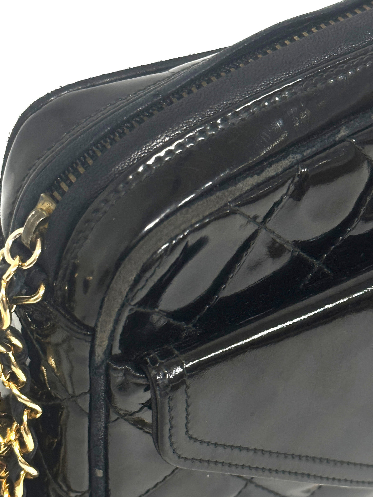Lynn's Closet Boutique black quilted patent leather Chanel camera bag with gold chain strap and zip closure