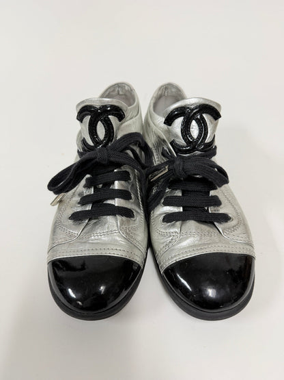 Lynn's Closet Boutique metallic silver lambskin Chanel sneakers with black patent cap toes and CC logo tongues.