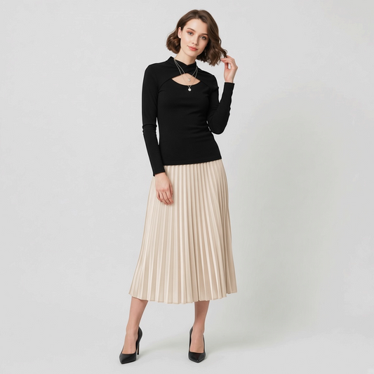 Lynn's Closet Boutique black Chiara Boni long-sleeve top with front cutout worn by a model with a pleated midi skirt