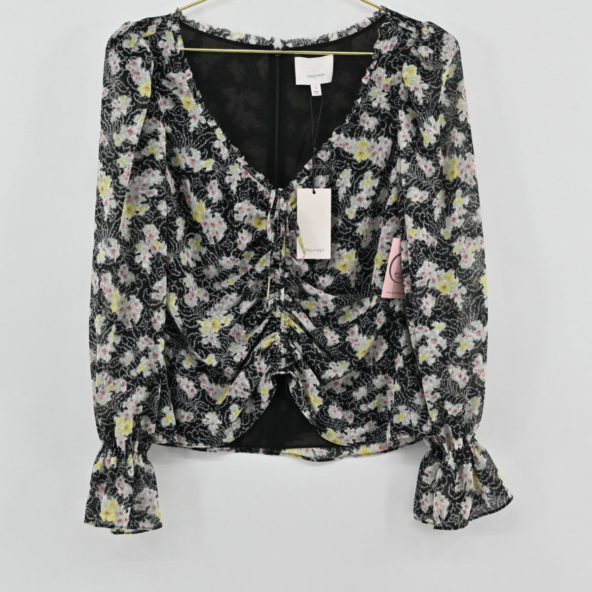 Lynn's Closet Boutique Cinq a Sept black floral long sleeve top with ruched front and ruffle cuffs
