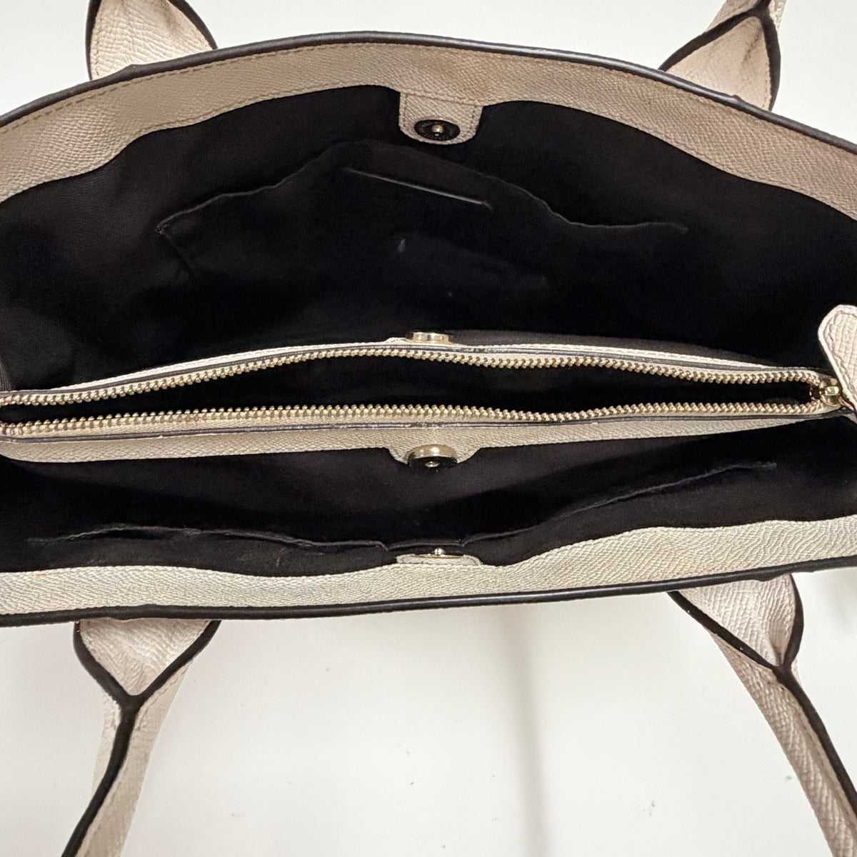 Lynn's Closet Boutique Coach Casey tote interior featuring a central zippered compartment and black fabric lining.