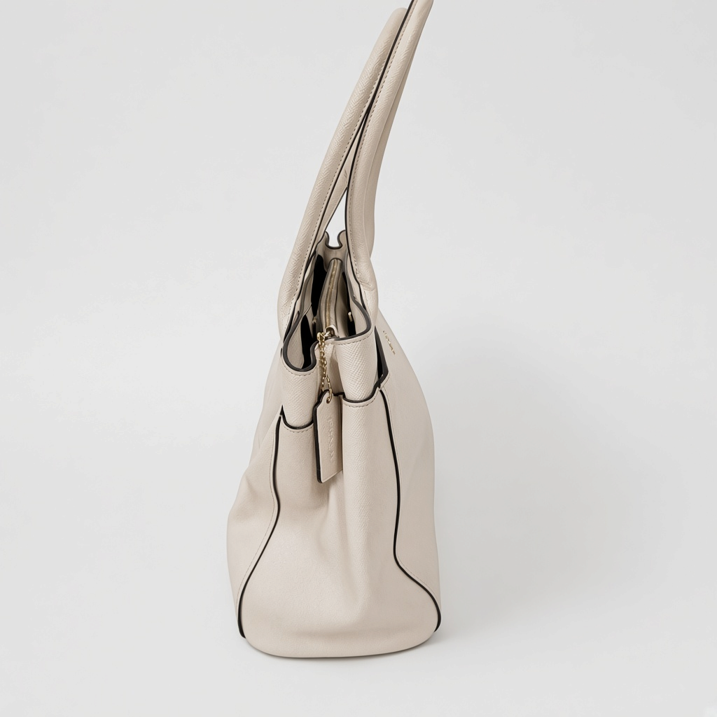 Lynn's Closet Boutique Coach Casey tote in chalk crossgrain leather, side view showing shoulder straps and gold detail