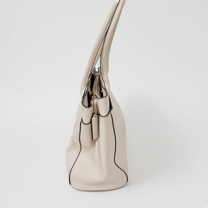 Lynn's Closet Boutique Coach Casey tote in chalk crossgrain leather, side view showing shoulder straps and gold detail