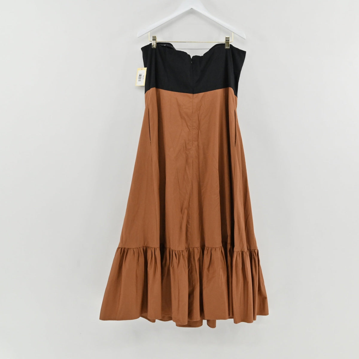 Lynn's Closet Boutique color-blocked strapless midi dress with a black bodice, brown skirt, and ruffled hem.