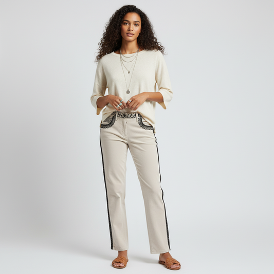 Model wearing Lynn's Closet Boutique cream Etro pants with black embroidery, paired with a cream top and sandals.
