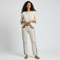 Model wearing Lynn's Closet Boutique cream Etro pants with black embroidery, paired with a cream top and sandals.