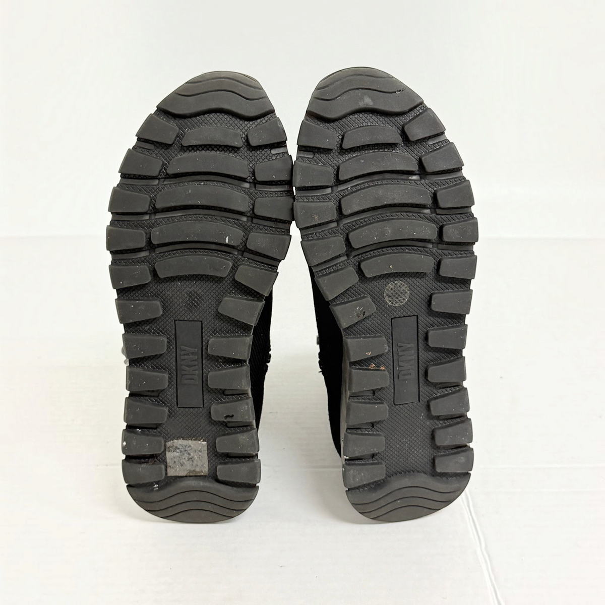 Lynn's Closet Boutique DKNY Miley black high-top sneaker lugged rubber outsoles showing tread pattern
