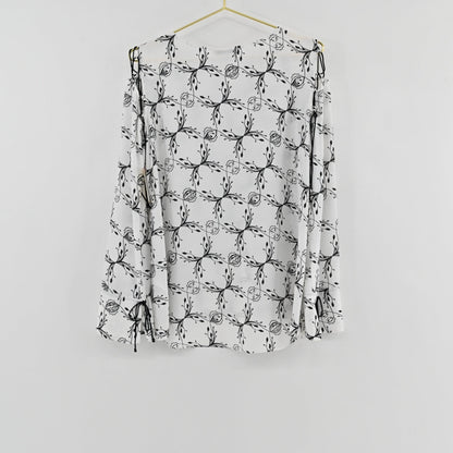 Lynn's Closet Boutique Dorothee Schumacher white top with black botanical print, cold-shoulder cutouts and ribbon ties.