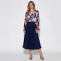 Model wearing Lynn's Closet Boutique Elie Tahari silk-blend floral blouse with ruffled details and navy pleated skirt