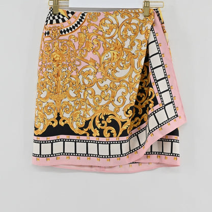 Lynn's Closet Boutique vintage Emanuel Ungaro wrap skirt featuring a pink, gold, and black baroque print with film-strip hem