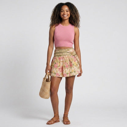 Model wearing Lynn's Closet Boutique Farm Rio Palm Dream linen mini skirt with floral print and double waistband.