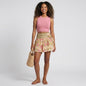 Model wearing Lynn's Closet Boutique Farm Rio Palm Dream linen mini skirt with floral print and double waistband.