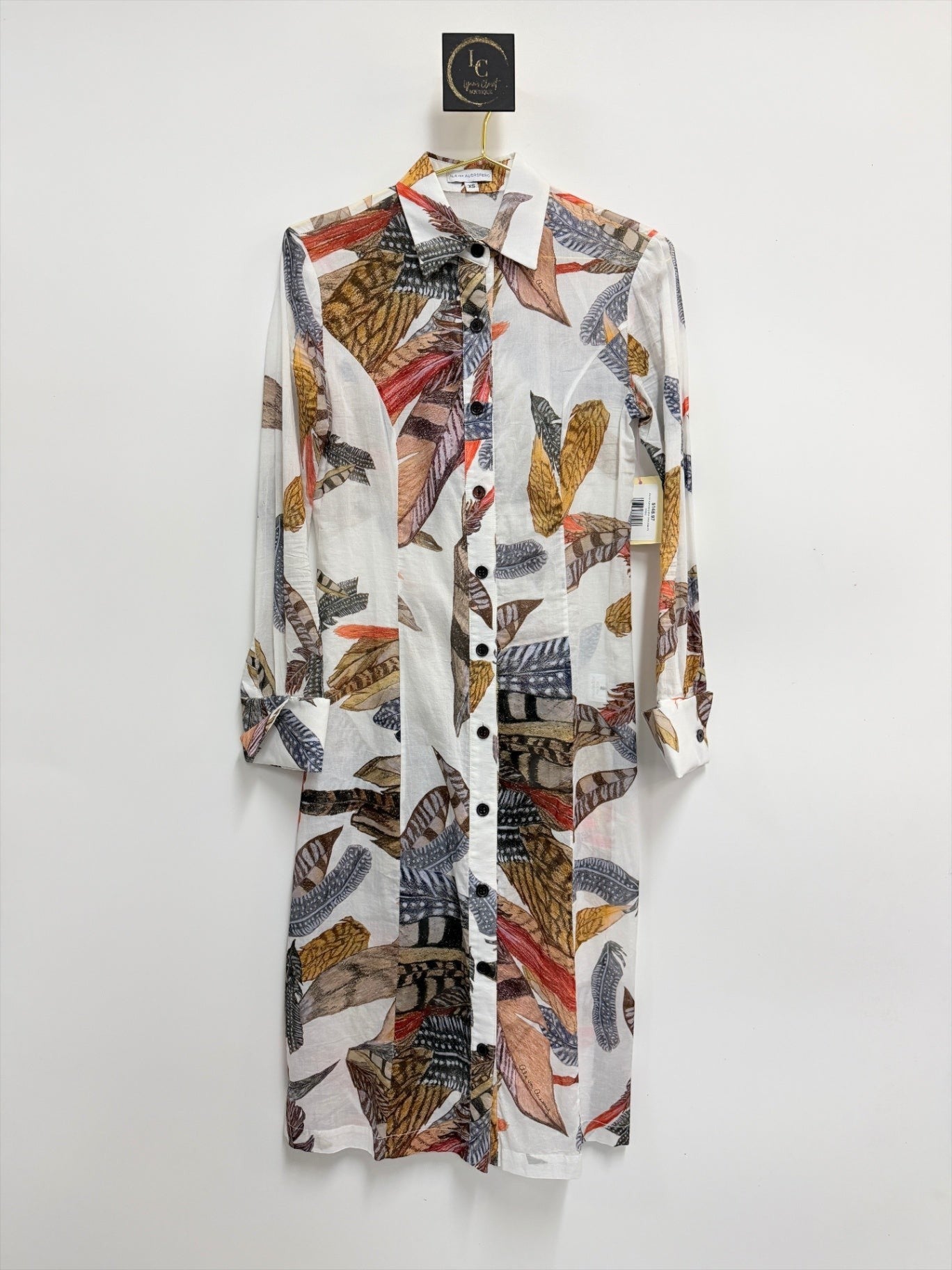 Lynn's Closet Boutique Ala von Auersperg midi shirt dress with a multi-colored feather print on white fabric.