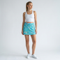 Model wearing Lynn's Closet Boutique Lilly Pulitzer Luxletic skort with turquoise floral print and white tank top