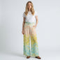 Model wearing Lynn's Closet Boutique wide-leg pleated pants with watercolor floral print in peach, yellow, and blue.
