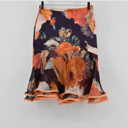 Lynn's Closet Boutique Manzoni Couture floral ruffle skirt with orange and cream painterly print on a dark base.