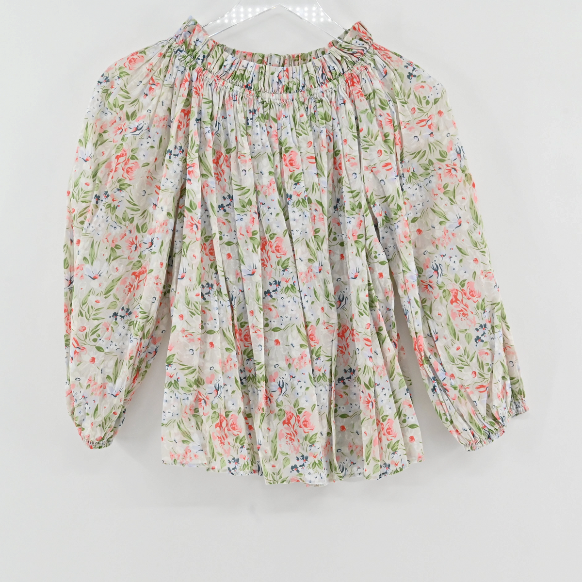 Lynn's Closet Boutique floral print smocked off-shoulder blouse with puff sleeves and elasticized cuffs.