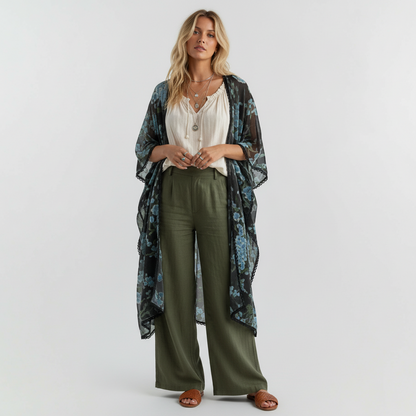 Model wearing a Lynn's Closet Boutique velvet burnout floral shawl with blue blossoms and scalloped lace trim.