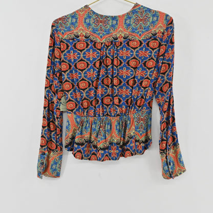 Back view of Lynn's Closet Boutique Free People long-sleeve top with a vibrant multi-colored floral paisley print.