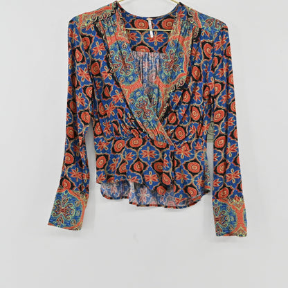 Lynn's Closet Boutique Free People Falling For You long-sleeve wrap top with a vibrant floral and paisley print.