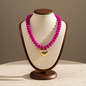 Lynn's Closet Boutique chunky fuchsia acrylic bead necklace with a polished gold-tone heart pendant on a display bust.