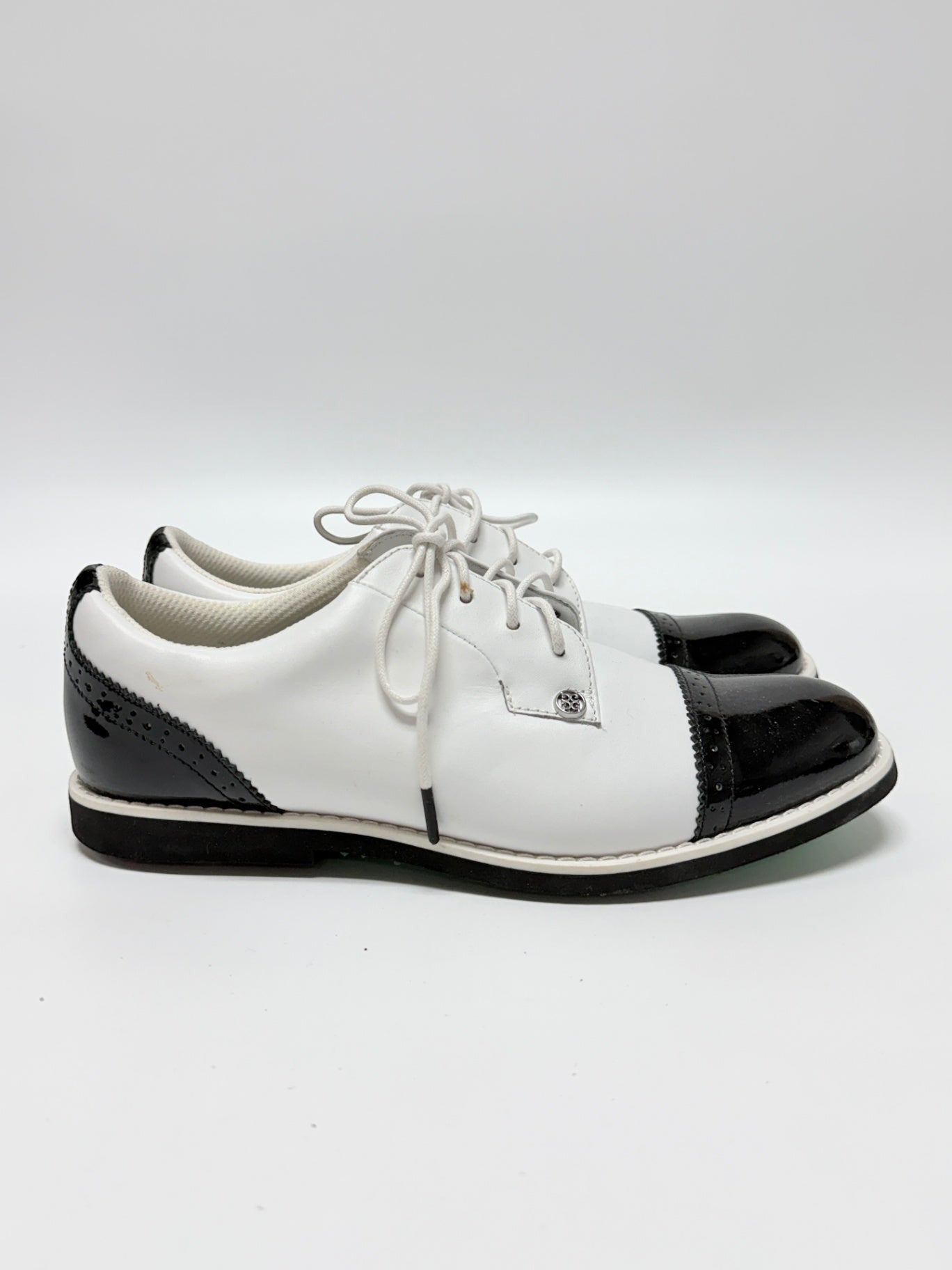 Lynn's Closet Boutique G/Fore Gallivanter white and black cap-toe golf shoes with brogue detailing, size 8.5.