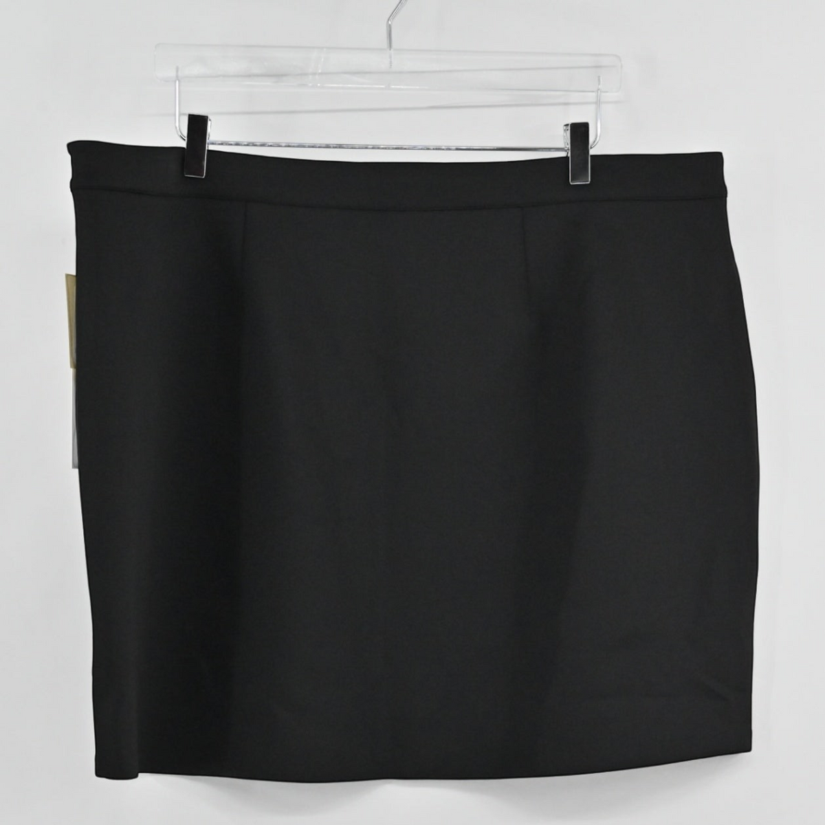Lynn's Closet Boutique Good American black mini skirt hanging on a hanger, featuring a clean minimalist design.