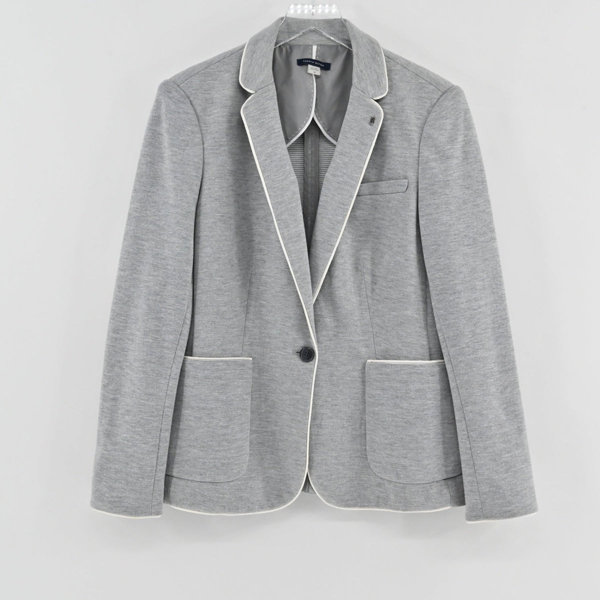 Lynn's Closet Boutique Tommy Hilfiger gray knit blazer with white contrast piping and single-button closure.