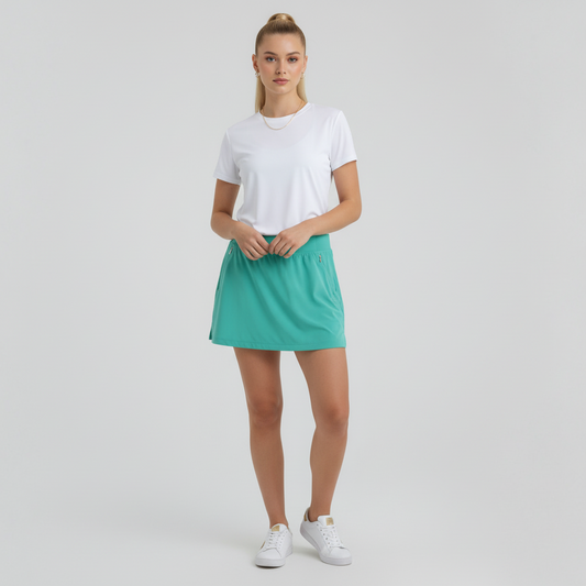 Lynn's Closet Boutique green Lilly Pulitzer athletic skort worn by a model with a white t-shirt and sneakers