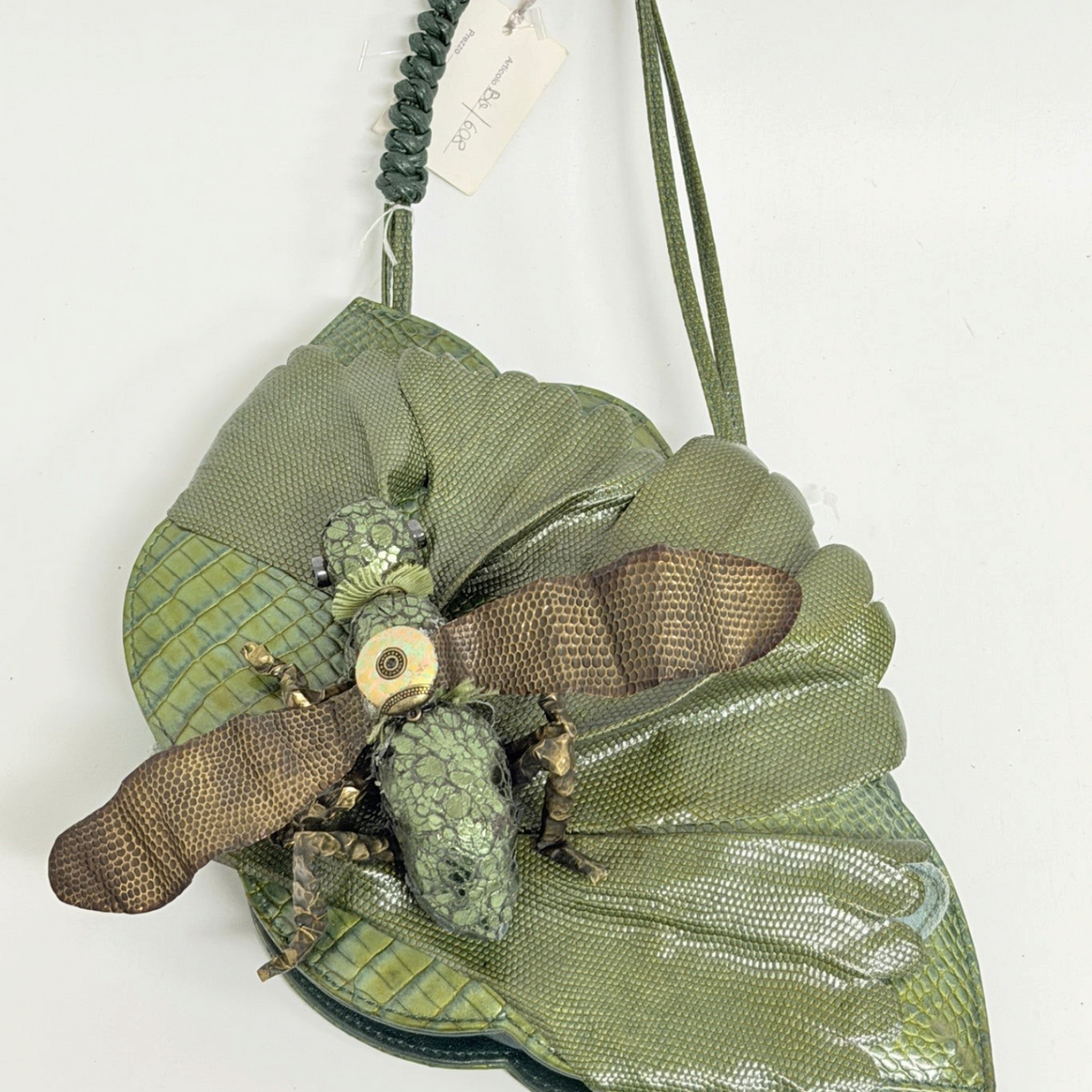 Lynn's Closet Boutique green leather grasshopper-shaped handbag with textured wings and a braided shoulder strap.