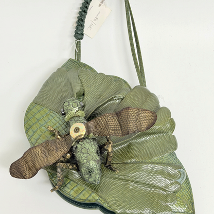 Lynn's Closet Boutique green leather grasshopper-shaped handbag with textured wings and a braided shoulder strap.