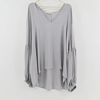 Lynn's Closet Boutique greige silk blouse with V-neckline, voluminous balloon sleeves, and a high-low hemline.