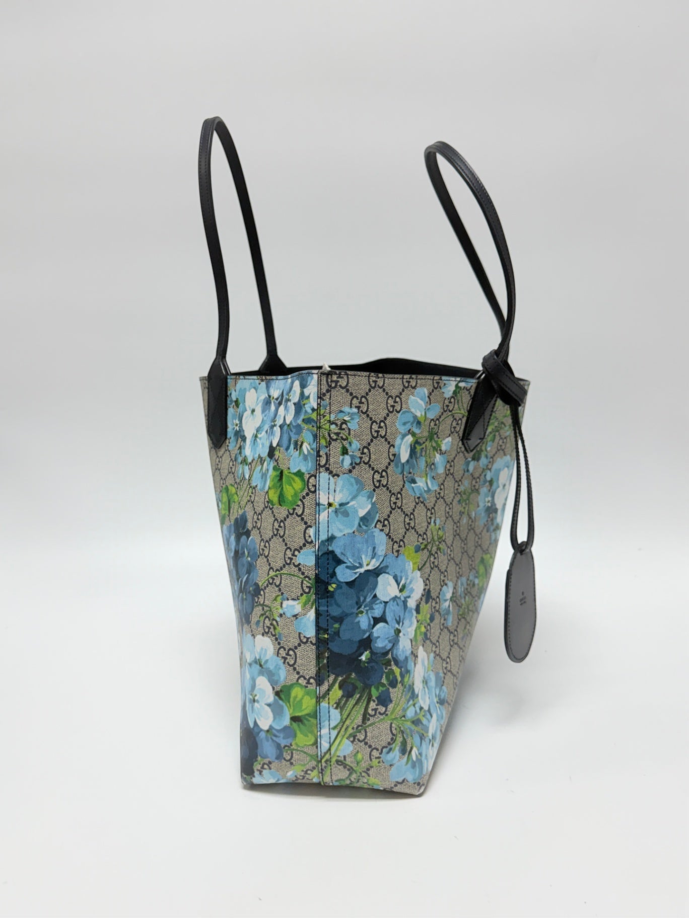 Lynn's Closet Boutique Gucci GG Supreme Blooms reversible tote in beige monogram canvas with blue floral print.