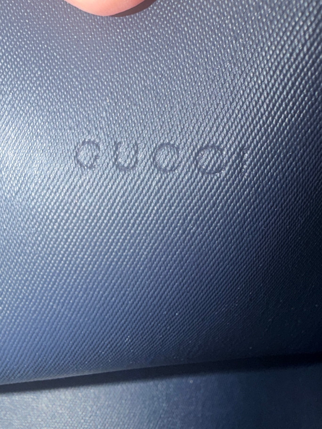 Lynn's Closet Boutique Gucci logo embossed on blue leather interior of a reversible tote bag