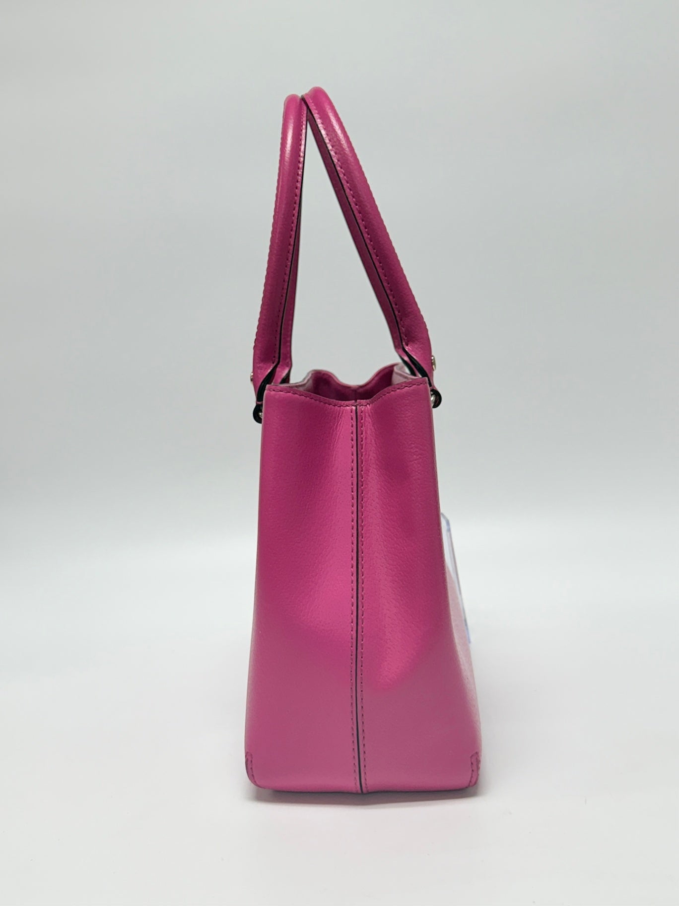 Lynn's Closet Boutique hot pink leather Kate Spade New York tote bag, side profile view showing structured design.