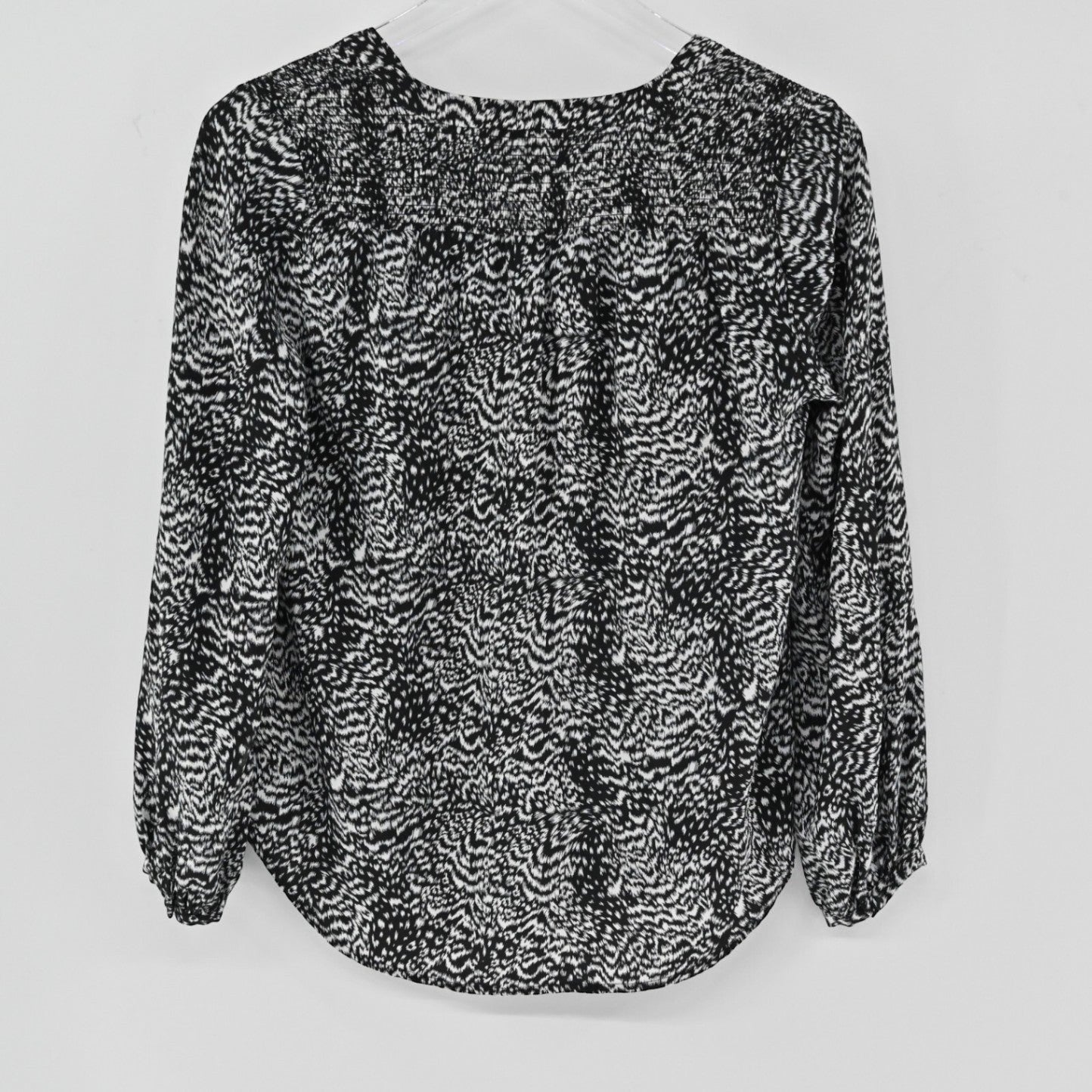Lynn's Closet Boutique Joie black and white animal print silk blouse with long sleeves and gathered cuffs, back view.