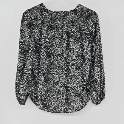 Lynn's Closet Boutique Joie black and white animal print silk blouse with long sleeves and gathered cuffs, back view.