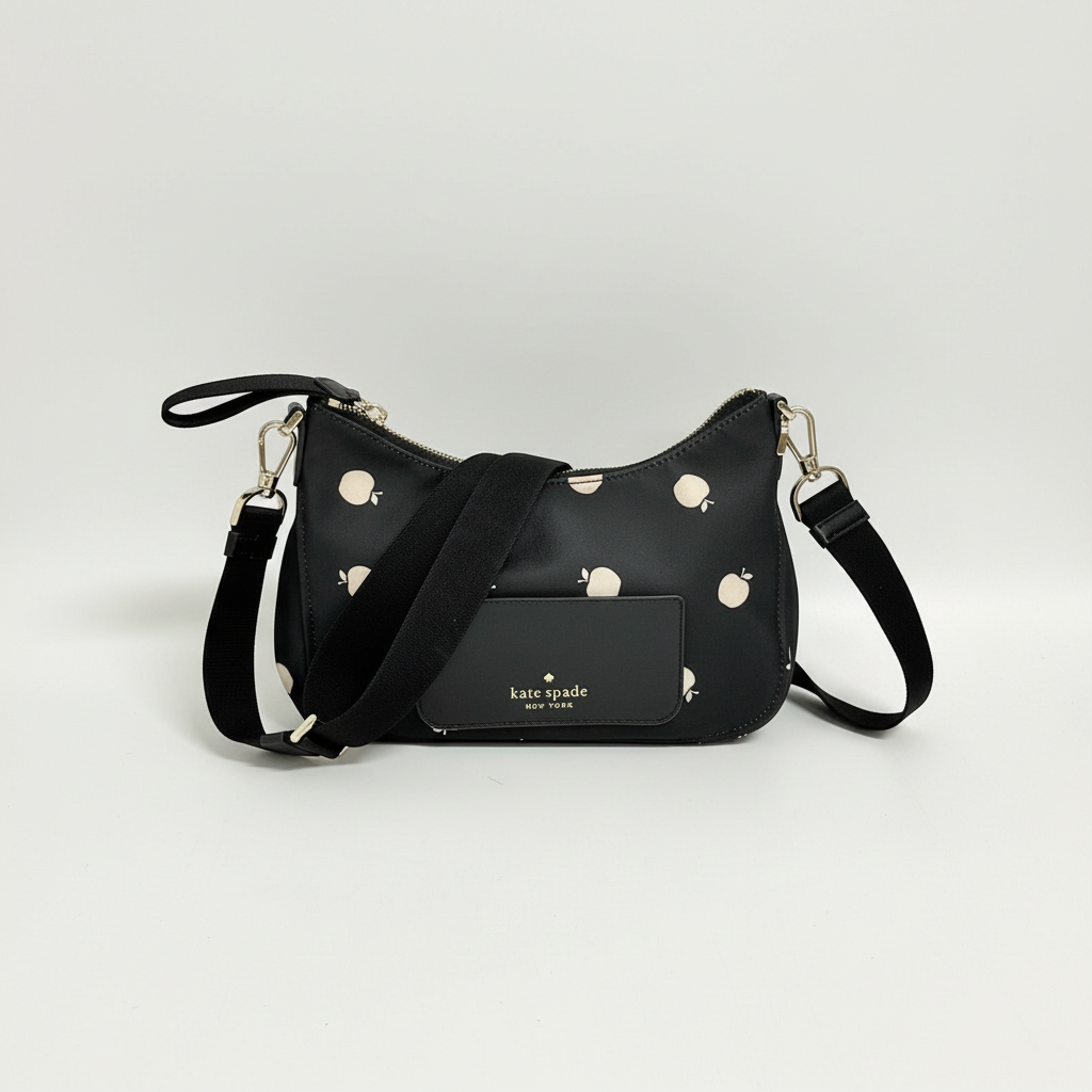 Lynn's Closet Boutique Kate Spade Chelsea nylon crossbody bag in black with a playful white apple print and logo.