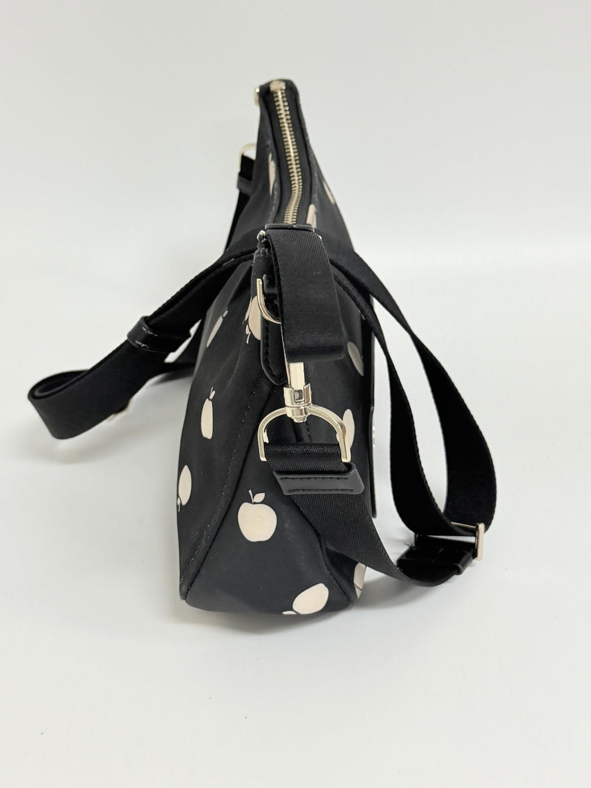 Lynn's Closet Boutique Kate Spade Chelsea nylon crossbody bag in black with white apple print, side view
