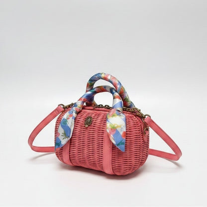 Lynn's Closet Boutique Kurt Geiger coral woven basket Boston bag with strawberry print scarf handle and eagle emblem.