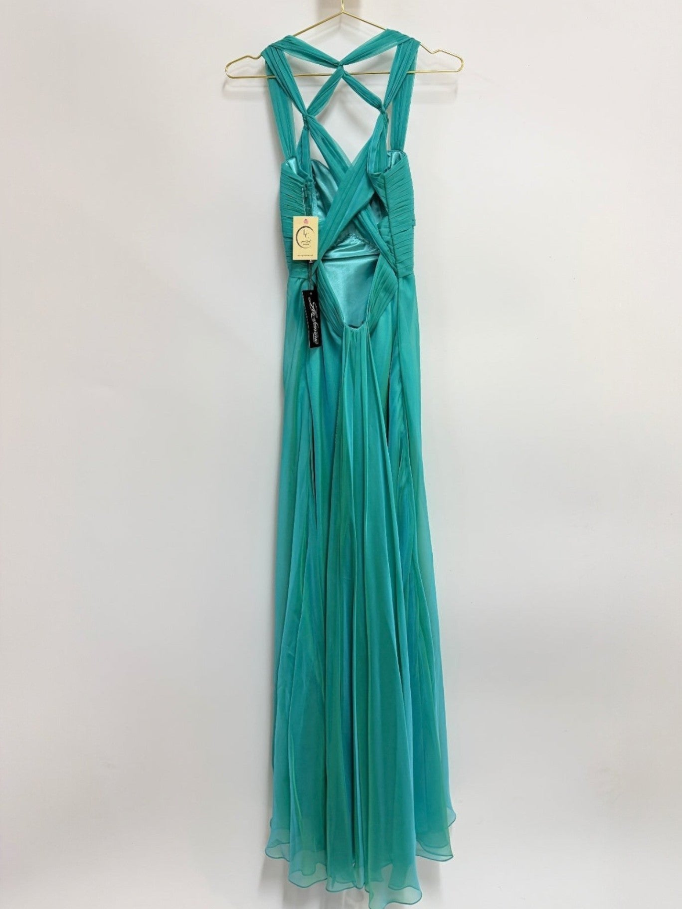 Lynn's Closet Boutique La Femme peacock green chiffon evening gown with a ruched bodice and crisscross back design.