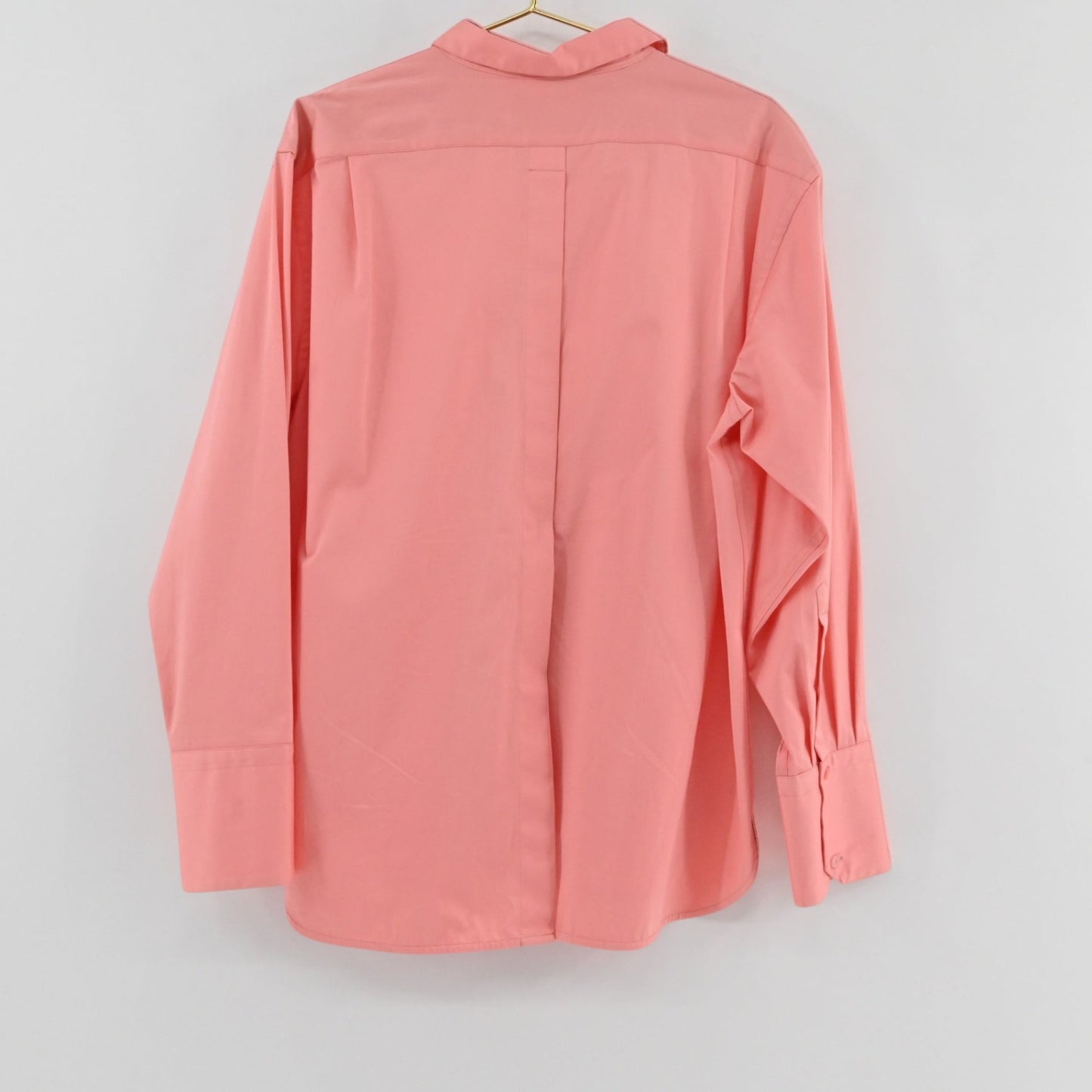 Lynn's Closet Boutique La Ligne coral button-down shirt with long sleeves and wide cuffs, back view.