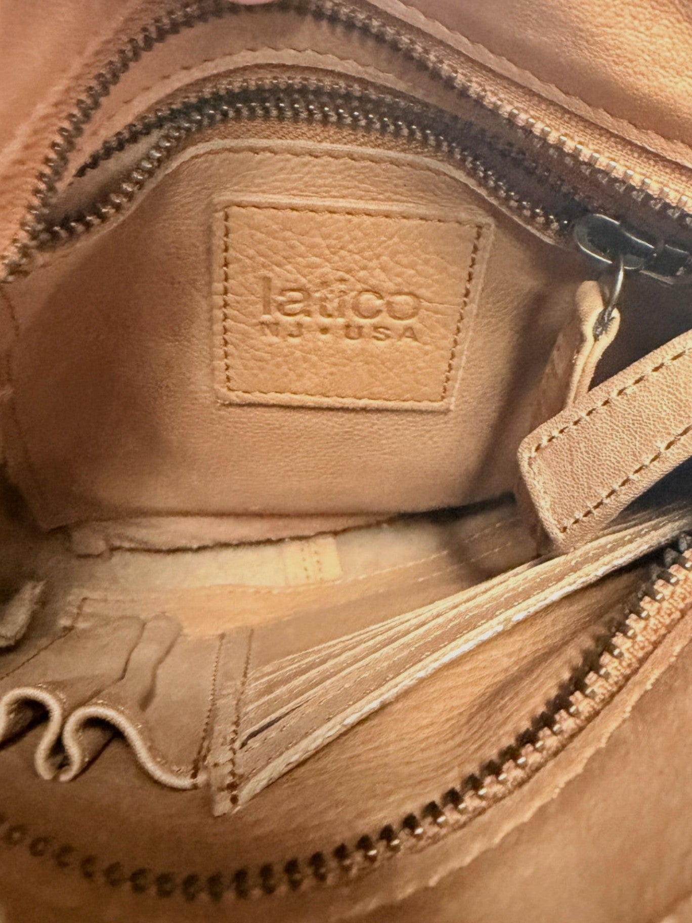 Interior of Lynn's Closet Boutique Latico Leathers brown leather bag showing brand logo patch and card slots