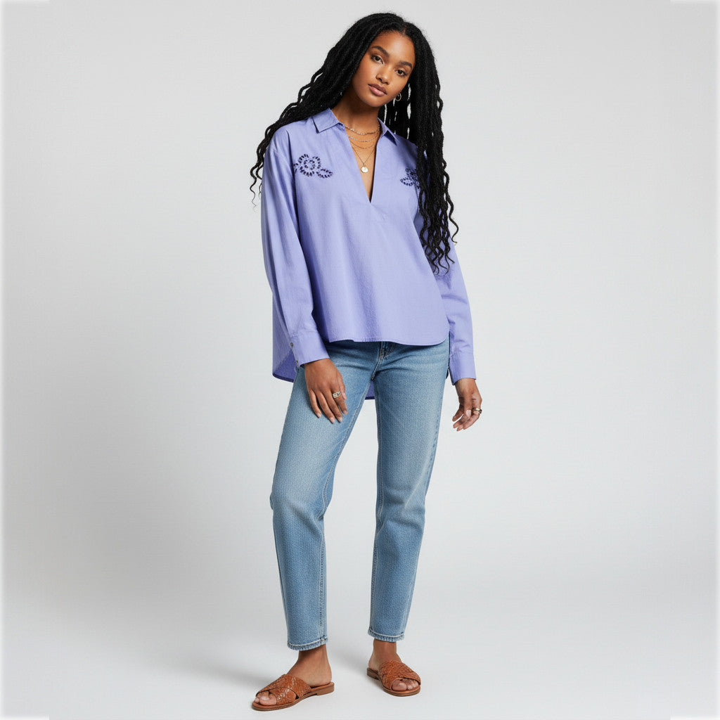 Lynn's Closet Boutique Anthropologie lavender popover blouse with eyelet embroidery worn by a model with blue jeans