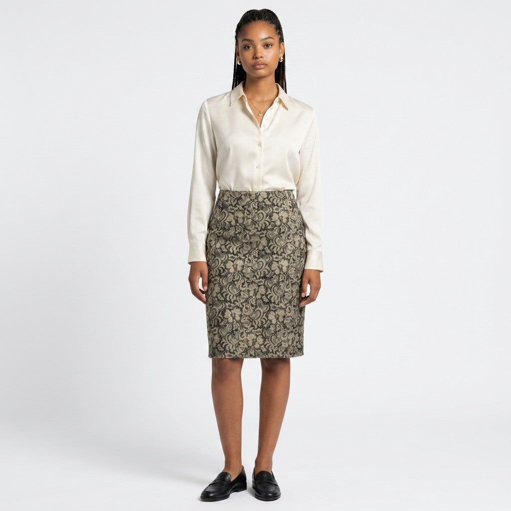Model wearing a Lynn's Closet Boutique LES COPAINS pencil skirt with a black and gold floral pattern and silk blouse.