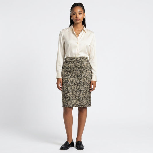 Model wearing a Lynn's Closet Boutique LES COPAINS pencil skirt with a black and gold floral pattern and silk blouse.