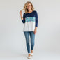 Lilly Pulitzer Chapman long-sleeve top in navy with a colorful floral print panel and white bottom. Cotton fabric.