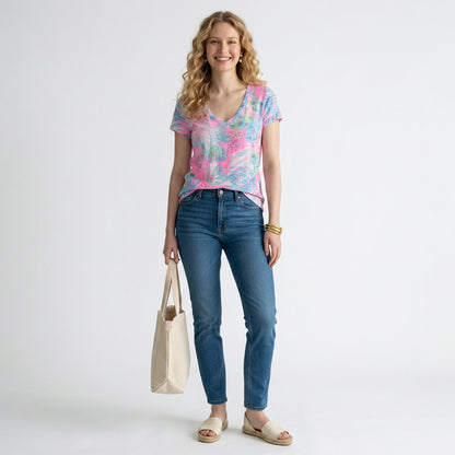 Lynn's Closet Boutique model wearing a pink and blue Lilly Pulitzer Etta V-neck tee with blue jeans and espadrilles.